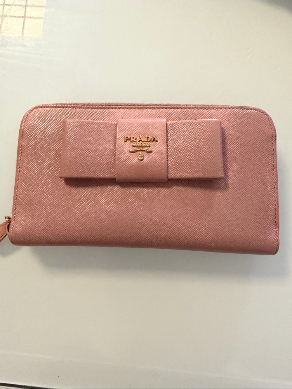 Prada Pink Saffiano Bow Zip Wallet. Check color